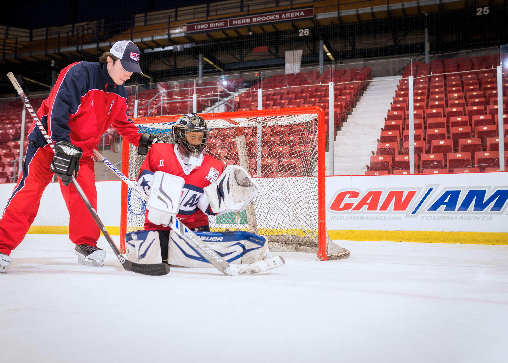 Coach with goalie in front of net